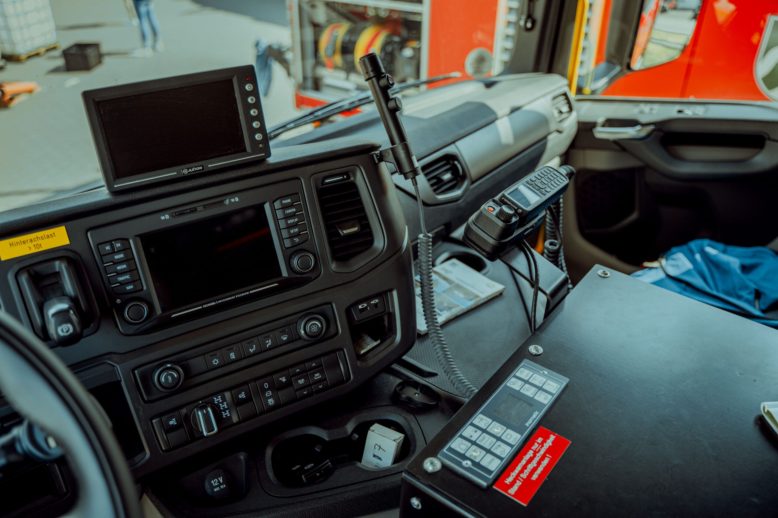 Detailed photo of a firetruck dashboard with communication devices and navigation screens.